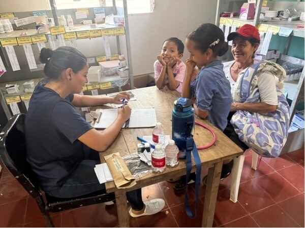 mother and children meeting with clinic staff