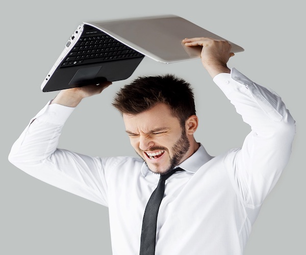 Man getting ready to throw a computer